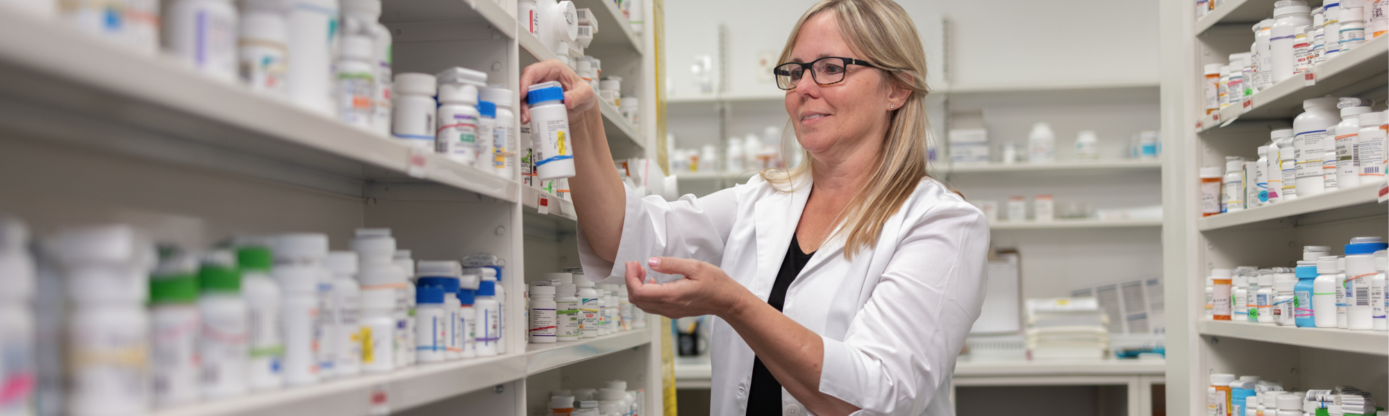Pharmacist looking at medicine bottle